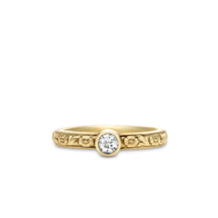 Gold ring with diamond on a white background